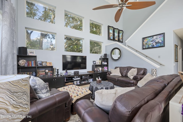 living room featuring a high ceiling and ceiling fan