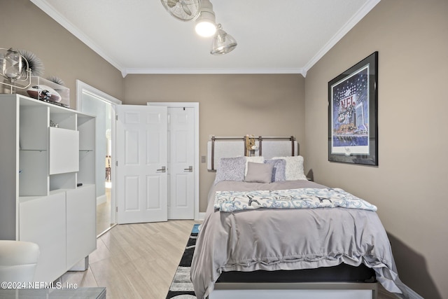 bedroom featuring light wood-type flooring and ornamental molding