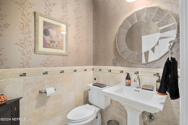 bathroom featuring tile walls and toilet