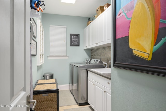 laundry room with cabinets and washer and clothes dryer