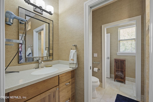 bathroom featuring vanity, tile patterned flooring, and toilet