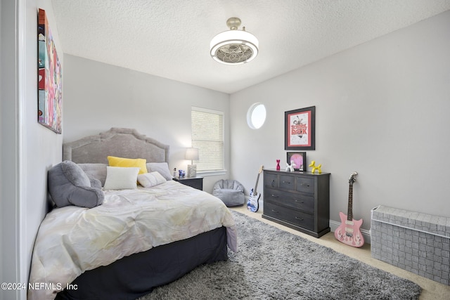 bedroom featuring a textured ceiling and carpet flooring