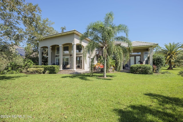 back of house with a lawn