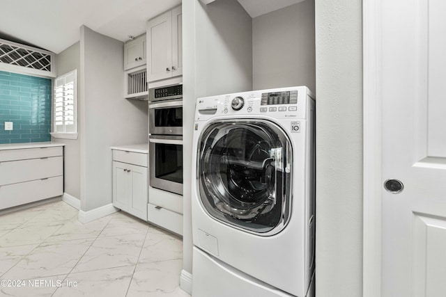 clothes washing area featuring washer / dryer