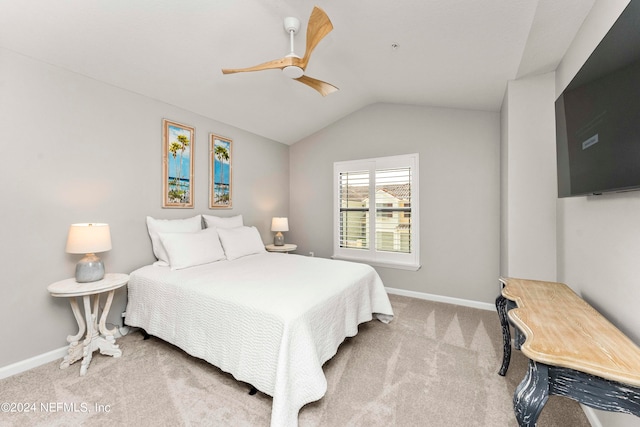 bedroom featuring baseboards, ceiling fan, carpet flooring, and vaulted ceiling