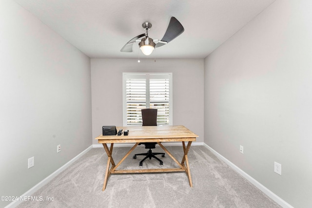 office area with light colored carpet, baseboards, and ceiling fan