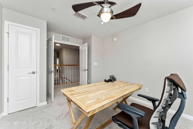 home office featuring ceiling fan, a textured ceiling, and carpet flooring