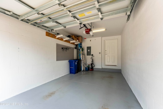 garage featuring electric panel and a garage door opener