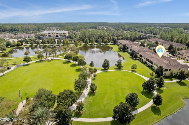 aerial view with a wooded view and a water view