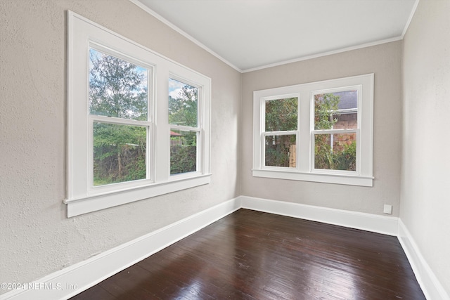 unfurnished room featuring hardwood / wood-style floors, a healthy amount of sunlight, and ornamental molding