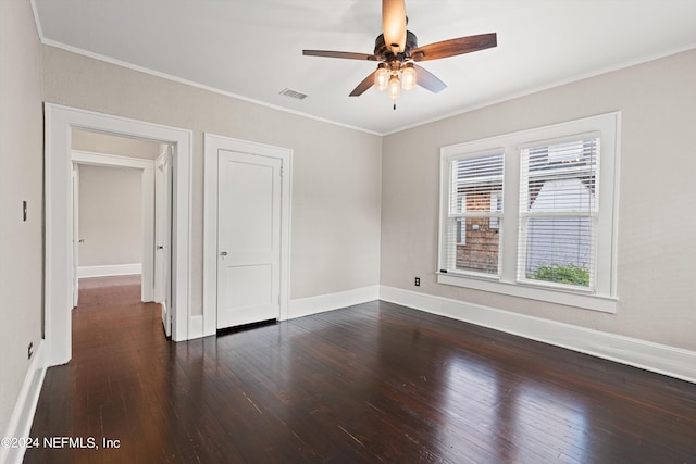 unfurnished bedroom featuring ceiling fan, crown molding, and dark hardwood / wood-style floors