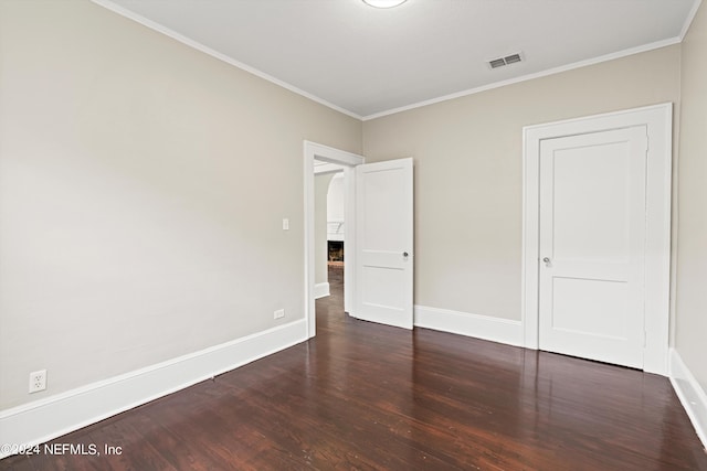 unfurnished bedroom featuring dark hardwood / wood-style floors and crown molding