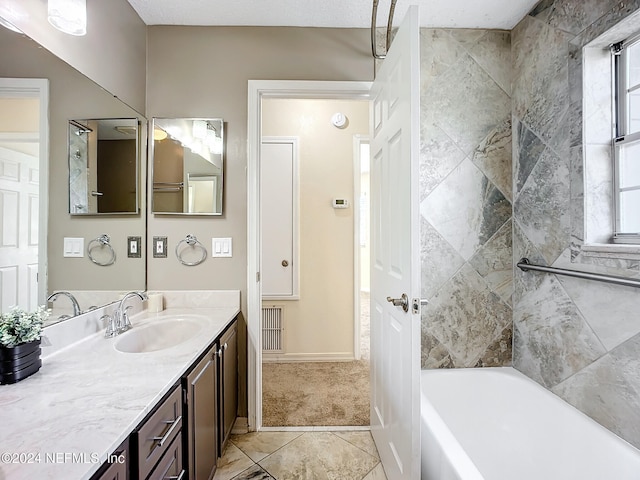 bathroom featuring tile patterned flooring, vanity, and a wealth of natural light