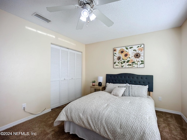 carpeted bedroom with ceiling fan and a closet