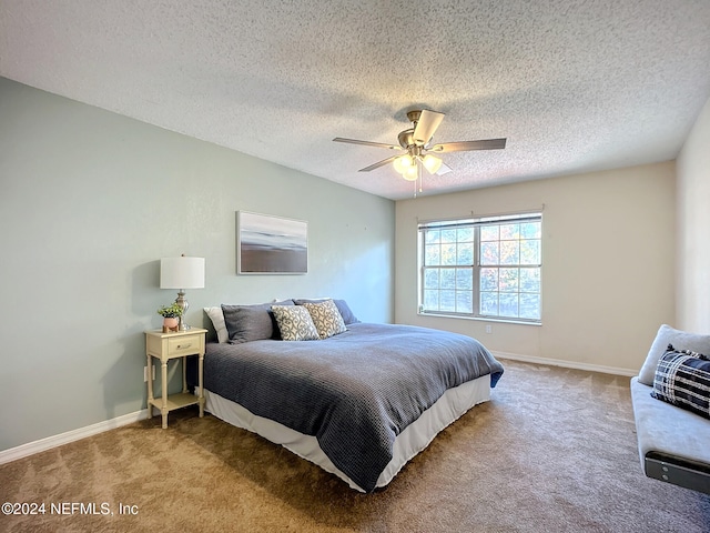 bedroom featuring ceiling fan, carpet, and a textured ceiling