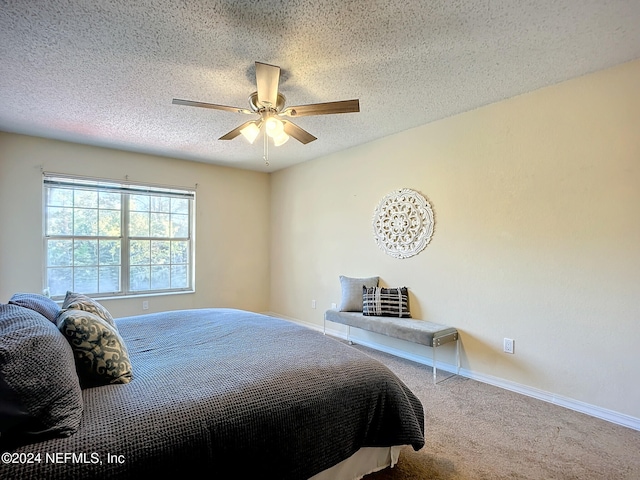 carpeted bedroom with a textured ceiling and ceiling fan