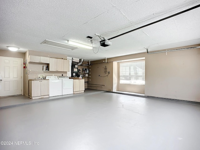 garage with independent washer and dryer and a garage door opener