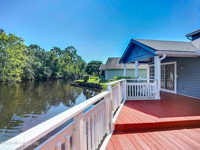 wooden deck featuring a water view