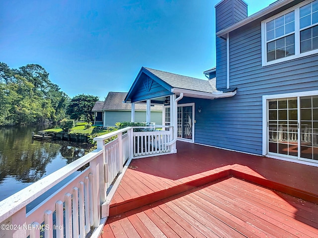 wooden terrace featuring a water view