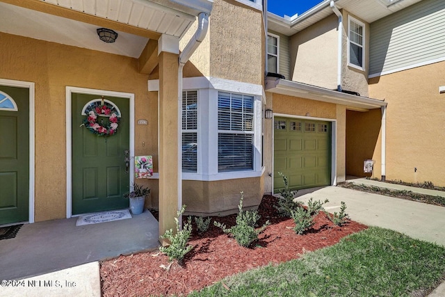 doorway to property with a garage