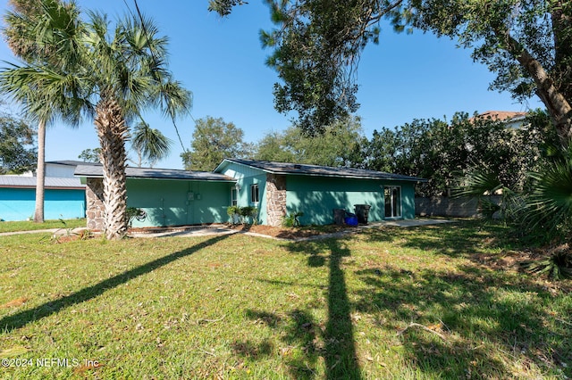 rear view of house featuring a lawn