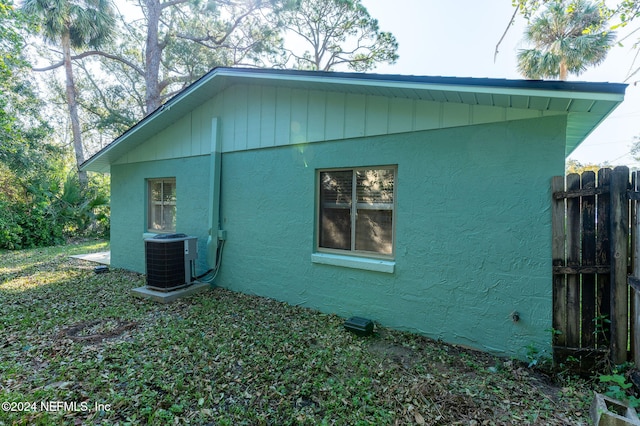 view of side of home with central AC