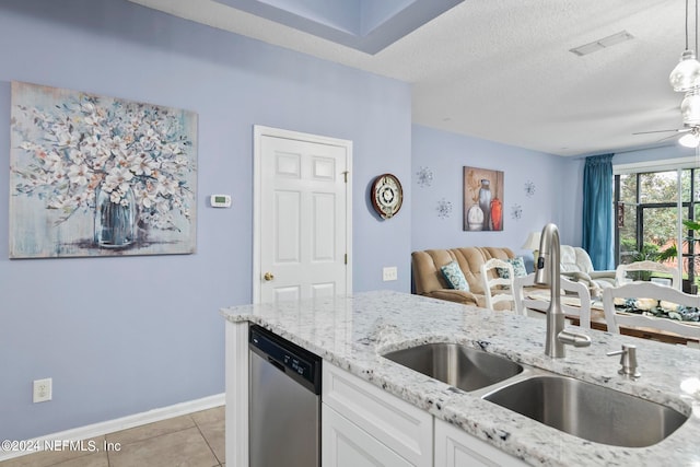 kitchen featuring white cabinets, light tile patterned floors, a textured ceiling, stainless steel dishwasher, and sink