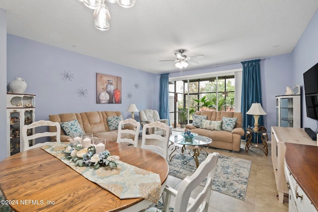 dining area featuring a textured ceiling, light tile patterned flooring, and ceiling fan