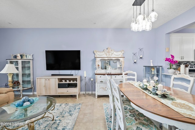 dining room featuring light tile patterned floors, a textured ceiling, and a notable chandelier