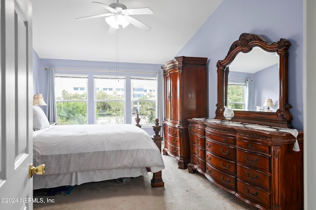 carpeted bedroom with vaulted ceiling and ceiling fan