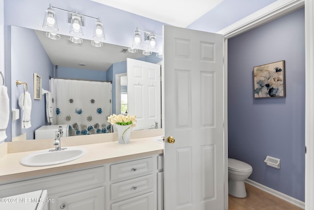 bathroom featuring walk in shower, tile patterned flooring, vanity, and toilet