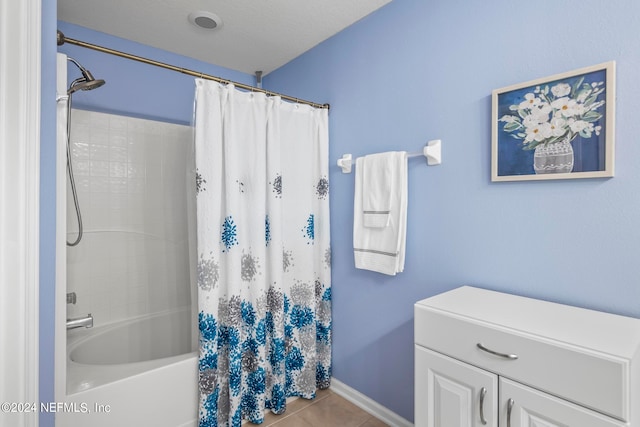 bathroom featuring shower / bathtub combination with curtain, a textured ceiling, and tile patterned floors