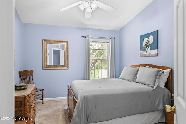 bedroom with ceiling fan and light carpet