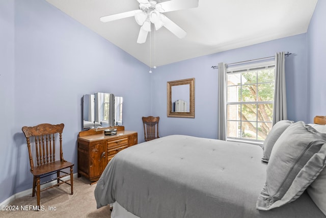 bedroom featuring ceiling fan, light carpet, and vaulted ceiling