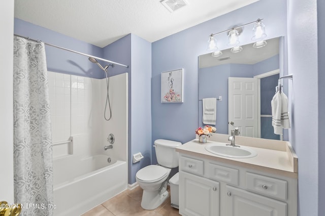 full bathroom with tile patterned flooring, a textured ceiling, shower / bath combo with shower curtain, vanity, and toilet