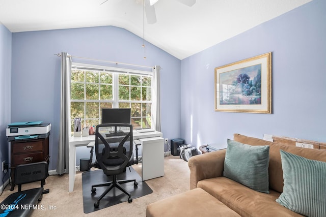 carpeted home office featuring lofted ceiling and ceiling fan