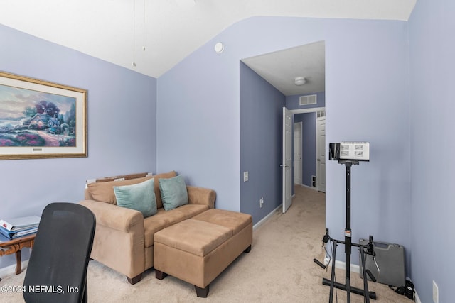 living area featuring lofted ceiling and light colored carpet