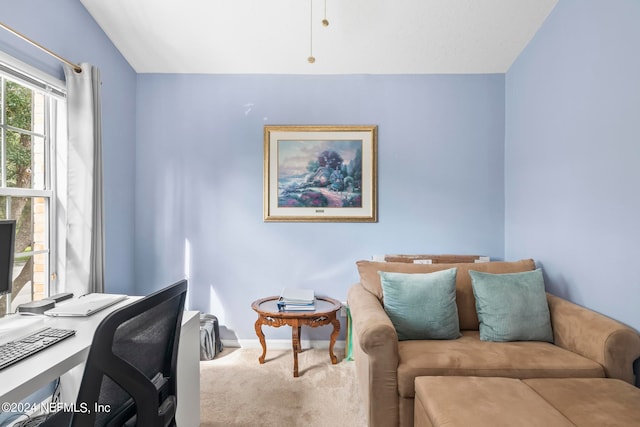 home office with lofted ceiling and carpet flooring