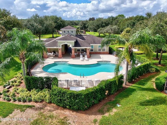 view of pool with a lawn and a patio area