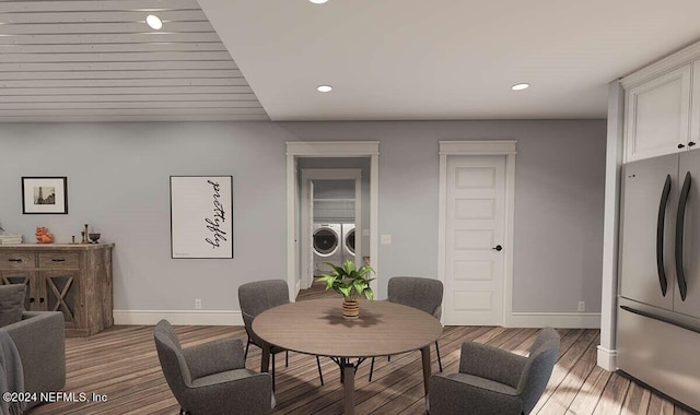 dining space with wood-type flooring and washer and dryer