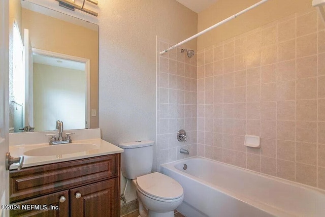 full bathroom featuring vanity, toilet, and tiled shower / bath