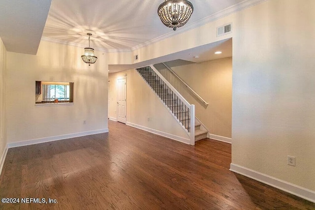 unfurnished living room with dark wood-type flooring, a chandelier, and crown molding