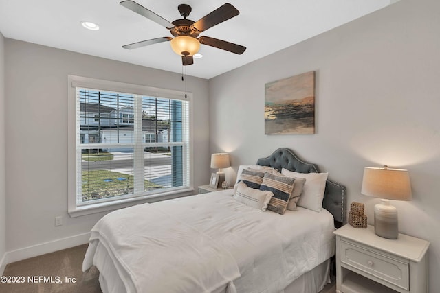 carpeted bedroom with multiple windows and ceiling fan