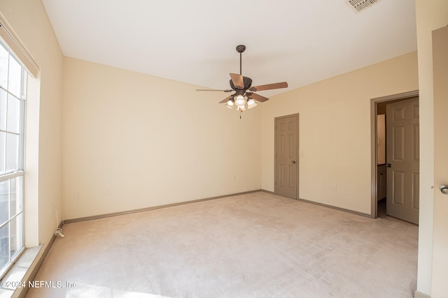 carpeted empty room featuring ceiling fan