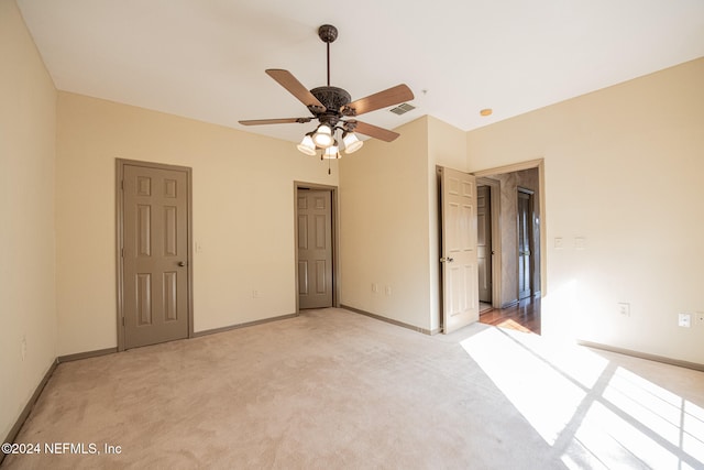 unfurnished bedroom with ceiling fan and light carpet