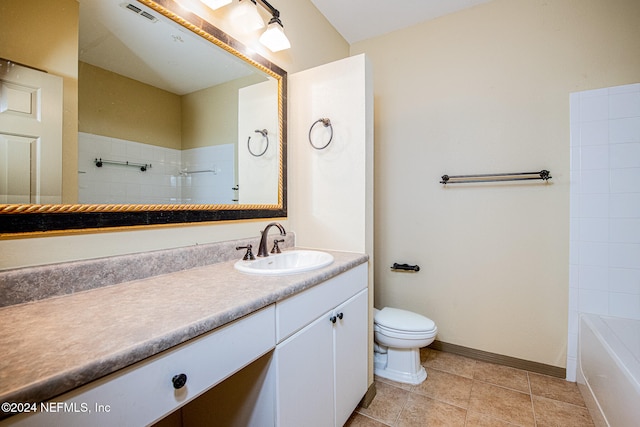 bathroom with vanity, tile patterned flooring, and toilet