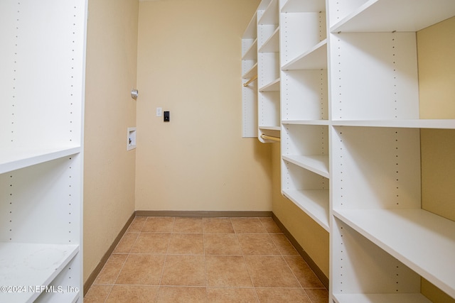 walk in closet featuring light tile patterned flooring