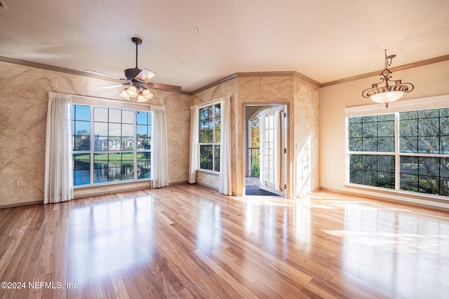 unfurnished living room with ornamental molding, a healthy amount of sunlight, and light hardwood / wood-style floors