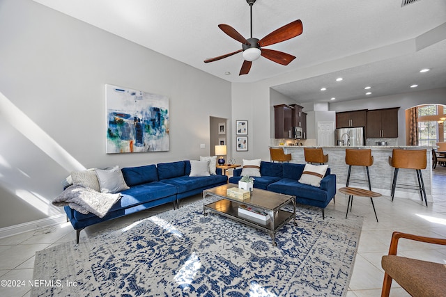 tiled living room featuring a textured ceiling and ceiling fan