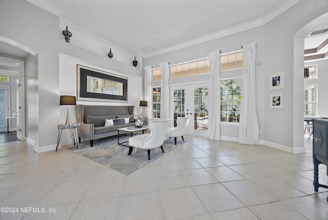 tiled living room featuring ornamental molding and french doors